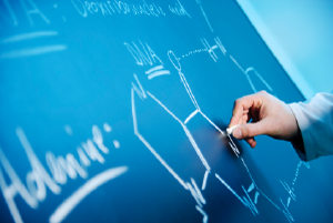 decorative image of someone drawing a chemical structure on a chalkboard.