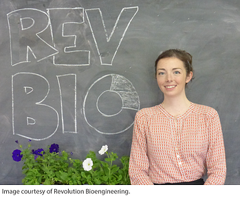 Keira Havens standing in front of a chalkboard a Revolution Bioengineering Synthetic Biology Startup 