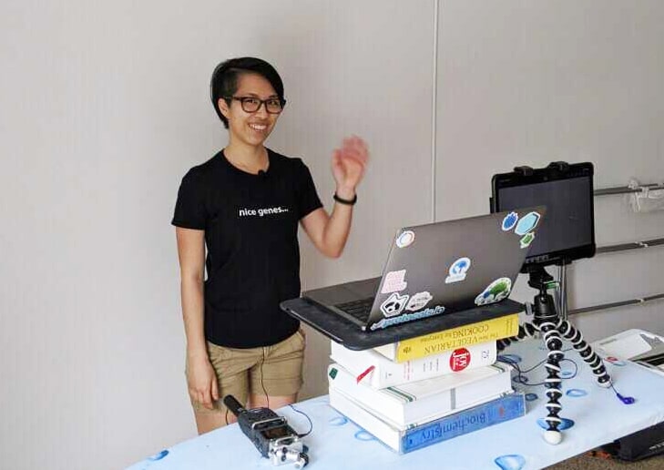 Addgene video shoot with a makeshift ironing board stand, laptop, and iPad on it