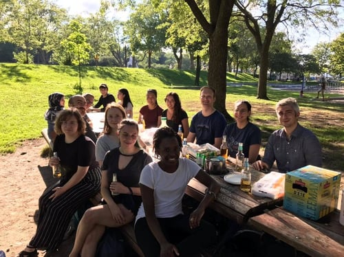 Members of Terry Hebert's lab sitting outside at a picnic table