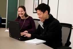 two people meeting looking at a laptop